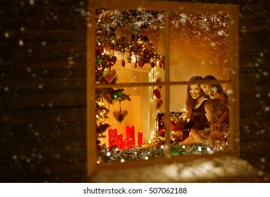 Christmas Window, Family Celebrating Holiday, Winter New Year Night, Mother And Children Inside Lighting House