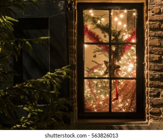 Christmas Window With Christmas Tree, Lights, Red Garlands And Christmas Star.