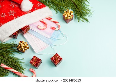 Christmas or winter composition. Pine cones and red berries on pastel blue background. Christmas, winter, new year concept. Flat lay, top view, copy space