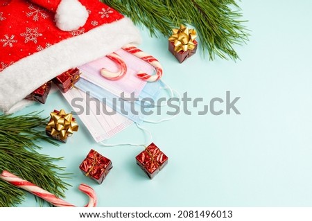 Christmas or winter composition. Pine cones and red berries on pastel blue background. Christmas, winter, new year concept. Flat lay, top view, copy space