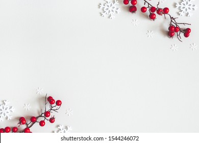 Christmas or winter composition. Snowflakes and red berries on gray background. Christmas, winter, new year concept. Flat lay, top view, copy space