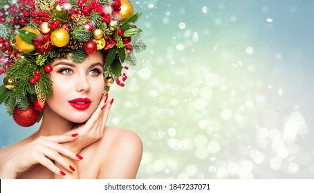 Christmas Woman Beauty Makeup, Xmas Wreath Hairstyle. Winter Fashion Model Portrait With Red Lips Make Up, Beautiful Girl On Blue Snowy Background