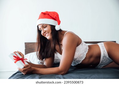 christmas woman in bedroom on bed christmas year gifts - Shutterstock ID 2395500873