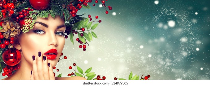 Christmas Woman Makeup. Winter Fashion Girl. Beautiful New Year and Christmas Tree Holiday Hairstyle, Make up, manicure. Beauty Model on winter Background. Creative Hair style decorated with Baubles