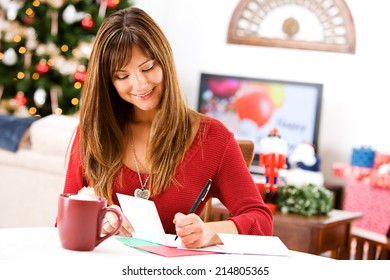 Christmas: Woman Writing Holiday Cards And Having Cocoa