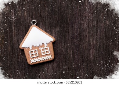 Christmas Wooden Background With Gingerbread Cookie House. Top View With Copy Space For Your Greetings