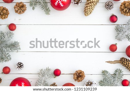 Christmas wooden background with snow fir tree, red balls and cones. Top view with copy space for your text mock-up flat lay