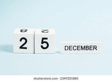 Christmas, wooden calendar with the date December 25 on a blue background with copy space. The concept of preparing for the celebration of Christmas and New Year and plans for the future - Powered by Shutterstock