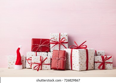 Christmas wrapped gift boxes on pink wooden background - Powered by Shutterstock