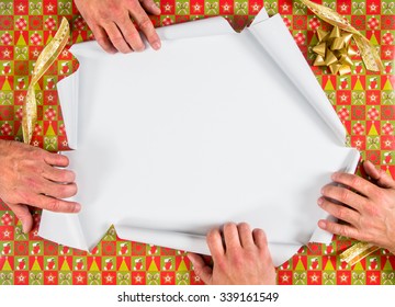 Christmas Wrapped Present Being Ripped Open By Four Hands