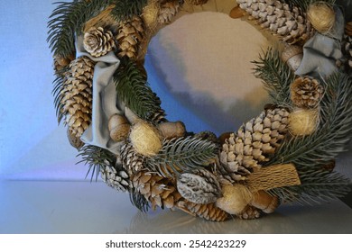 Christmas wreath artificial pine branches pinecones leaves decorative beads. Holiday gift hand made home door decor different angle top side front view magical glow festive cool blue yellow lighting - Powered by Shutterstock