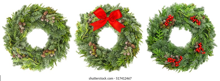 Christmas wreath from fir, pine and spruce twigs with cones, berries and ribbon bow isolated on white background - Powered by Shutterstock