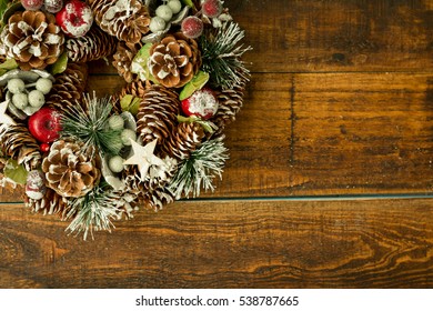 Christmas wreath formed by natural elements as pine cones and fruits - Powered by Shutterstock