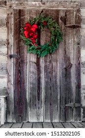 Christmas Wreath Hung On A Log Cabin Door