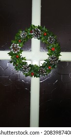 Christmas Wreath On The Door. Green Boxwood Wreath With Pine Cones And Berries.