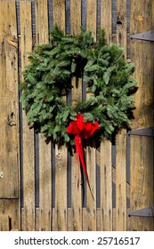 A Christmas Wreath On An Old Barn Door