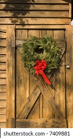 A Christmas Wreath On An Old Barn Door