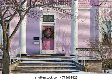 Christmas Wreath On Pink Victorian House With Snow