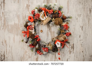 Christmas Wreath On A Rustic Wooden Front Door Close Up