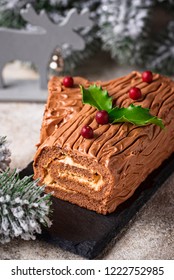 Christmas yule log cake. Traditional chocolate dessert on festive background