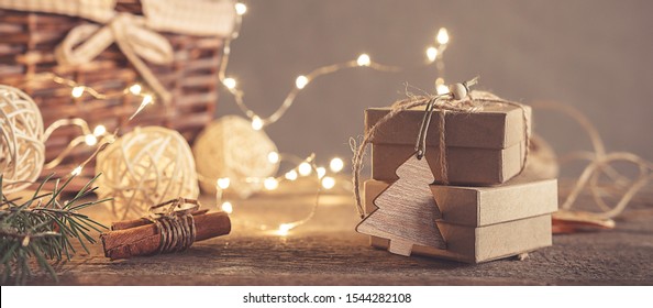 Christmas and zero waste, eco friendly packaging gifts in kraft paper on a wooden table, eco christmas holiday concept, eco decor banner - Powered by Shutterstock