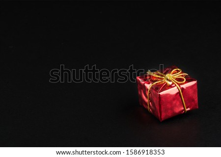 Christmass  tmass gift in red paper isolated at black background