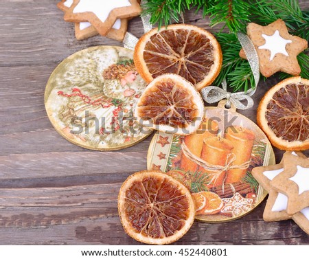 Christmas-tree decorations and dried oranges on a wooden background with space for the text. Top view.