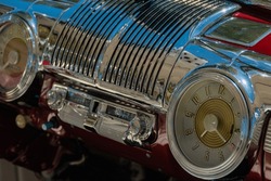 The Chrome Dash On A Classic Car Featuring A Chrome Radio And Vintage Dash Clock.