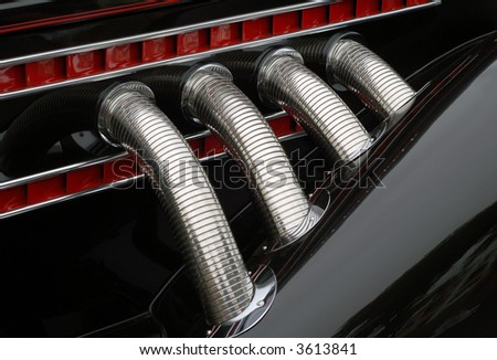 Chrome exhaust pipes on classic automobile
