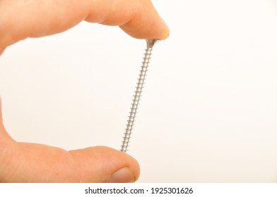 Chrome metal screw and on isolated white background, crosshead screw
