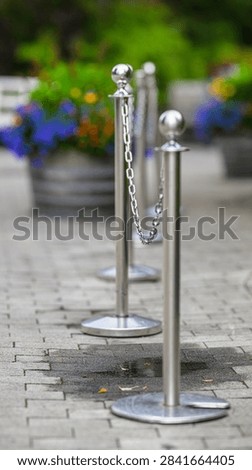Chrome queue barrier posts with chains outside attraction