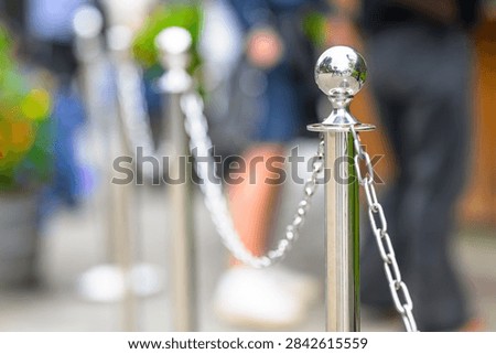 Chrome queue barrier posts with chains outside attraction