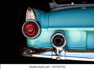 Chrome rear tail lights, bumper and exhaust of convertible turquoise Thunderbird vintage car. - Powered by Shutterstock