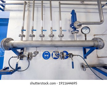 Chrome Steel Gas Pipes With Ball Valves And Fittings On The Wall. The Main Bio Methane Pipeline With Thin Branches.