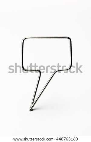 Chrome wire tweet or remark. Blank speech bubble made of chrome wire isolated on white. Ready for inserting text. Shallow depth of field.