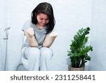 chronic constipation concept with Asian woman sitting in the toilet having the lumpy and difficult passage of hard stools and bowel movements 