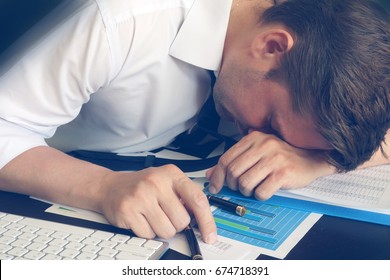 Chronic fatigue syndrome concept. Overworked businessman is sleeping at desk.