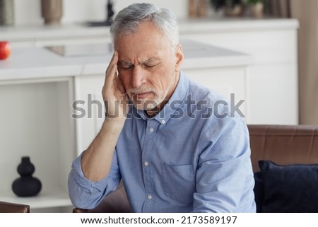 Chronic illness concept. Portrait of exhausted mature aged man with closed eyes, suffering from headache disease. Sick senior person feel stressed, migraine or depression