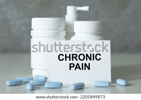 Chronic pain -Diagnosis written on a white piece of paper. Treatment and prevention of disease. Syringe and vaccine with drugs. Medical and Healthcare concept. Selective focus
