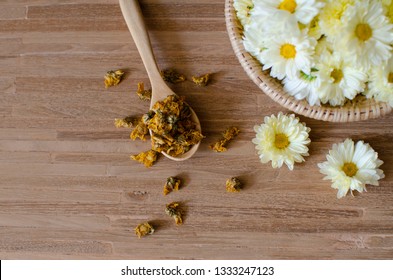 Chrysanthemum flower tea, herb flower. Fresh and dry  chrysanthemum white and yellow flower on wooden background. - Powered by Shutterstock