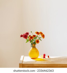 chrysanthemums in glass vase on white background