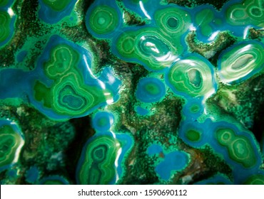 Chrysocolla and Malachite. Green and blue polished gemstone. Chrysocolla is a hydrated copper phyllosilicate mineral. Malachite is a copper carbonate hydroxide mineral. Background mineral texture.