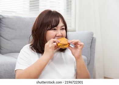 Chubby Asian Woman Enjoy Eating Beef Cheese Burger