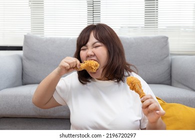 Chubby Asian Woman Enjoy Eatting Fried Drumstick Chicken