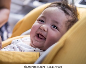 Chubby Baby With Double Layer Skin Of Chin And Messy Hair Smile And Look At The Camera , Sit In The Car Seat Before Trip Start.