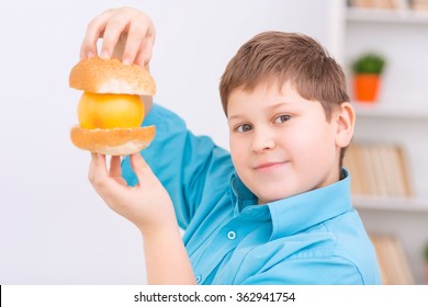 Chubby Kid With Buns And Orange. 