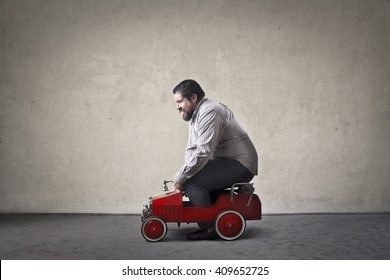 Chubby Man Driving Toy Car