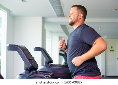 Chubby Man Walking On Running Track, Warming Up On Gym Treadmill