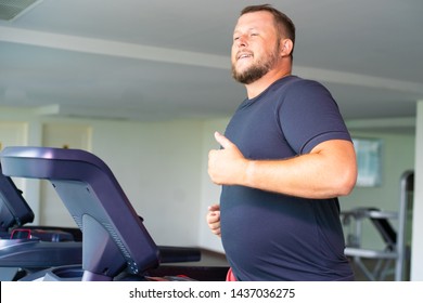 Chubby Man Walking On Running Track, Warming Up On Gym Treadmill