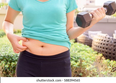 Chubby Woman Hand Holding Her Own Belly And Dumbbell For Exercising In Public Park